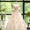 A gown featuring a built-in 3D garden, with thousands of exquisitely crafted lifelike flowers gently embracing the skirt; custom orders are available.